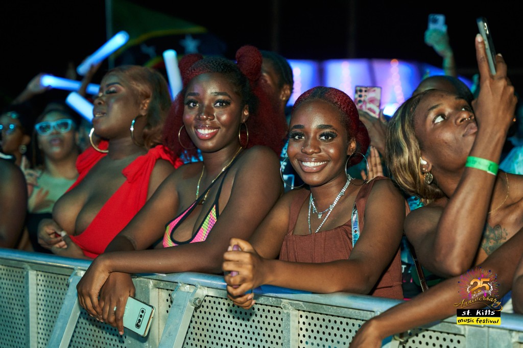 Young ladies smile in the crowd during the festival's night performances.